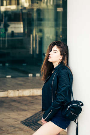 Pretty teenage girl posing on the streetの写真素材