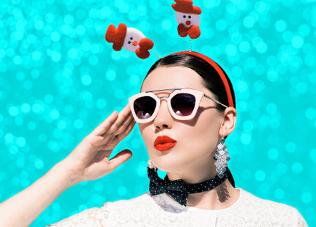 Portrait of a pretty woman in christmas outfit and sunglasses with bright painted lips on a colorful...