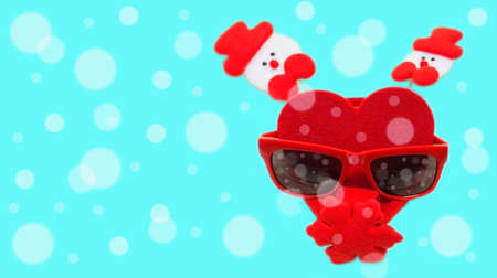 Christmas scene with red sunglasses on a bright colorful backgroundの写真素材