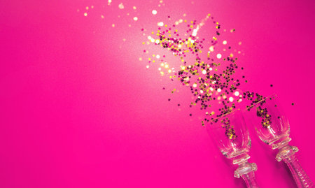 Pink background with decorative metallic stars and two vintage glasses. Holiday theme backdrop....