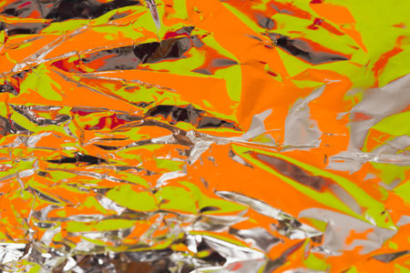 Crumpled foil colorful backdrop. Abstract background.