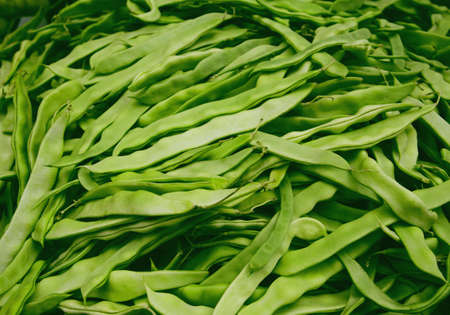 Fresh raw green haricot pods at the market. Organic product suitable for vegeterians and vegans. Healty food concept backgroundの写真素材