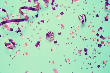 Mint background with shiny confetti. Holiday and festive backdrop. Flat lay style. Christmas and birthday gift. Invitation card themeの写真素材