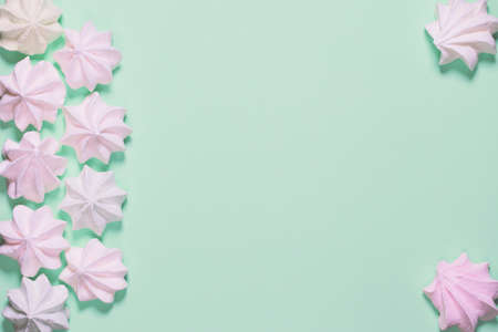 Small  meringues on colorful background. Festive and party concept. Minimal style. Flat lay. Top view. Copy spaceの写真素材