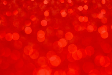 Abstract red bokeh background. Defocused christmas lights. Party, holiday and festive concept. Invitation card themeの写真素材
