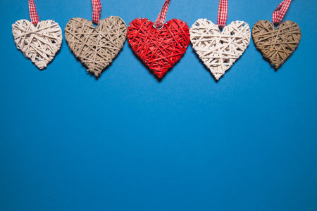 Decorative hearts on blue background. Abstract backdrop with copy space. Love and romance theme....