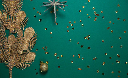 Golden decorative branch, balls, cone and sequins on bright background. Christmas backdrop....