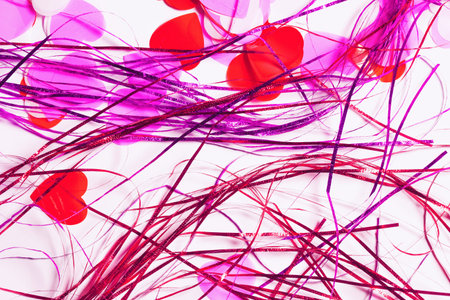 Colorful confetti in a heart shape on white background. Valentine day concept. Abstract backdrop