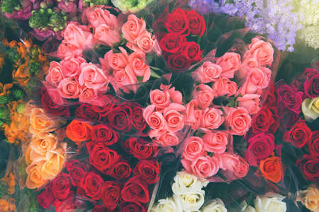 Bouquets of colorful roses at the market close up. Beautiful floral background. Top view. Selective focus