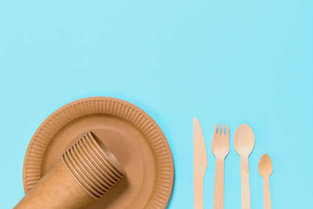 Eco friendly craft paper tableware on blue background. Recycling concept. Copy space. Zero waste themeの写真素材