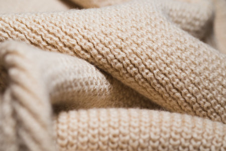 Knitted fabric wool texture close up as a background. Abstract backdrop.