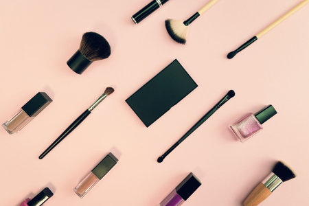 Decorative cosmetics with makeup brush  on colorful background. Minimal style composition. Top view