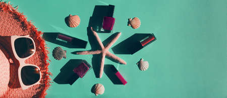 Summer composition with white trendy sunglasses, hat, starfishes, shells and makeup set on colorful background. Vacation and travel accesories concept.の写真素材