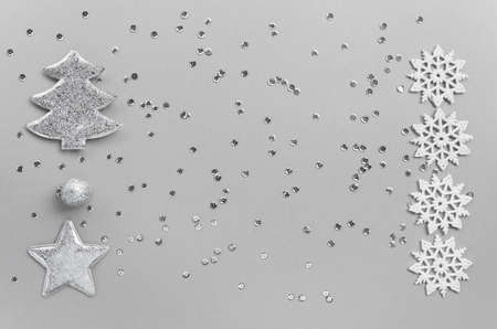 Christmas composition with decorative silver star, fir tree, balls and snowflakes on pastel background with sequins.Celebration and party concept. Top view. Flat layの写真素材