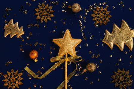 Christmas composition with decorative golden star, fir tree, balls and snowflakes on blue background...