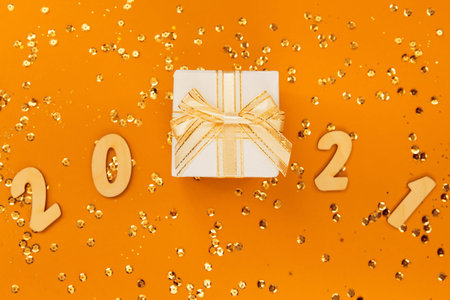 Christmas composition with present box and 2021 figures on colorful background with...