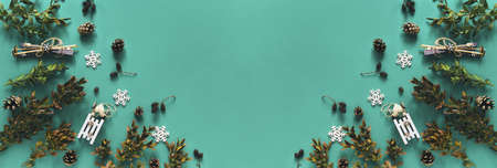 Winter backdrop with boxwood branches, decorative sledge and ski on green background. Top view. Flat layの写真素材