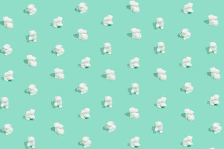 Easter pattern composition made of white easter bunnies on pastel background. Minimal holiday conceptの写真素材