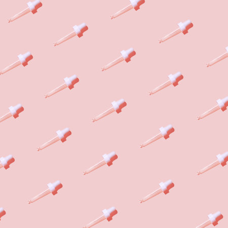 Cosmetic serum droppers on pastel background. Skin care concept. Beauty rituals theme. Top view. Flat lay. Minimal styleの写真素材