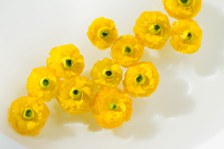 Yellow buttercup flowers in water. Summer composition with sun and shadows. Nature concept. Top...