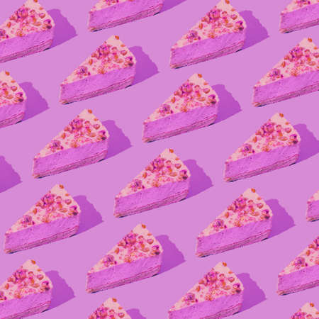 Creative pattern made of piece of cake on pink background. Dessert and confectionary concept. Minimal styleの写真素材