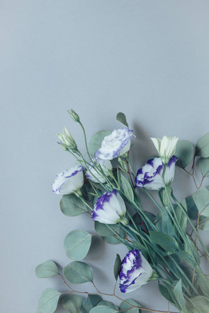 Bouquet of beautiful eustoma flowers on pastel background. Nature concept. Summer floral composition. Top view. Flat lay.の写真素材