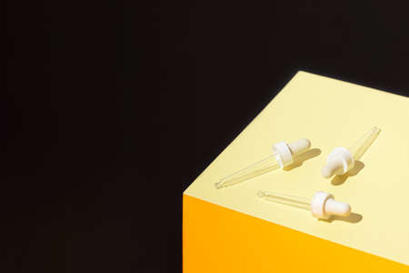 Cosmetic serum droppers on colorful geometric background. Skin care concept. Beauty rituals themeの写真素材