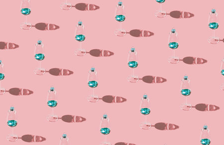 Holiday theme pattern made of decorative glasses with shiny green sequins on pastel background....
