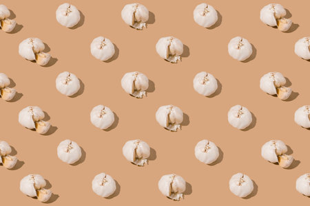 Creative pattern made with garlic on beige background. Healthy food ingredient concept .Minimal...