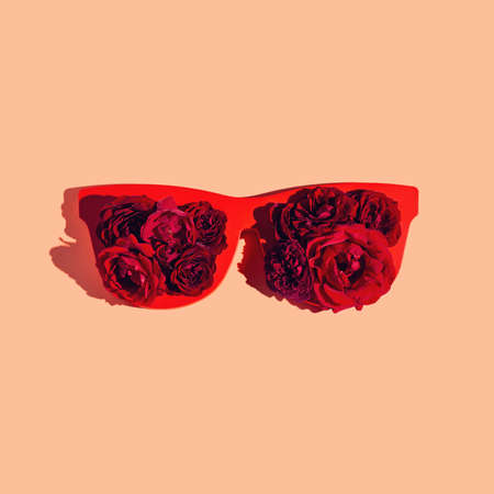 Creative composition made of red sunglasses with rose buds on pastel background. Summer fashion concept. minimal style. top view. flat layの写真素材