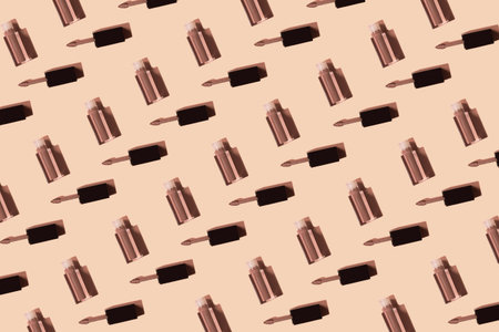 Creative pattern made of colorful liquid lipstick or lip gloss. Set of decorative cosmetics on...