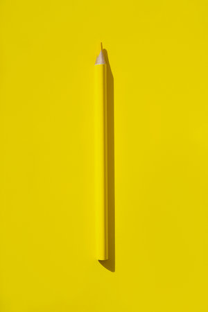 Minimal style composition made of wooden pencil on yellow background. top view. flat lay. Back to school concept.の写真素材