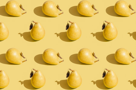 Creative pattern made raw pears on pastel yellow background with shadow. Healthy food ingredient...