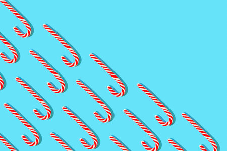 Minimal style winter composition with lollipos on light blue background. Chrismas celebration and holiday concept. top view. flat lay.の写真素材