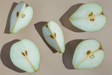 Creative layout made of raw sliced pears on pastel background with shadows. minimal style. Healthy...