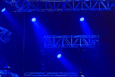 Stage lights on a console at a concert against a dark blue background