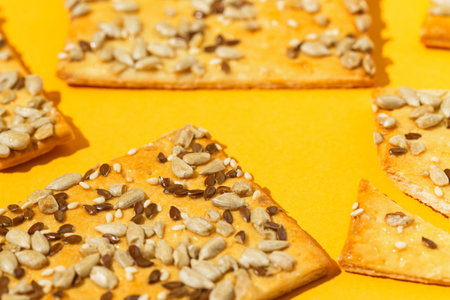 Crunchy cereal cookies closeup on bright orange background. Healthy dessert concept.の写真素材