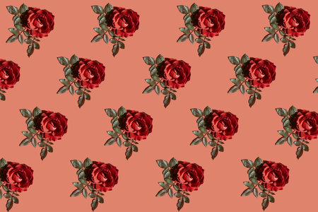 Beautiful floral pattern made of red rose bud on bright background. minimal style. greeting card theme. nature concept. top view. flat layの写真素材