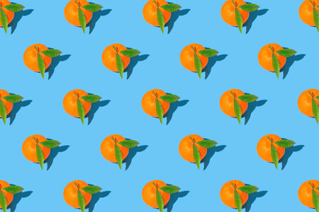 Creative compisition made of fresh orange tangerins on bright blue background. Healthy food concept....