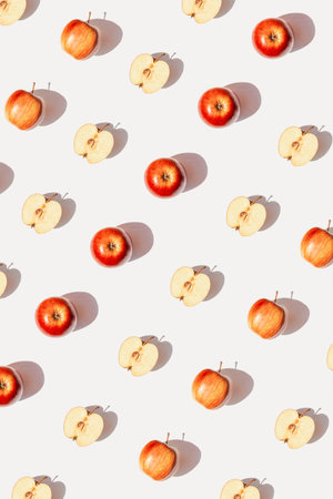 Creative pattern made of apple fruits on white background with shadow. Healthy food and vitamin concept. Minimal style. Top view. Flat layの写真素材