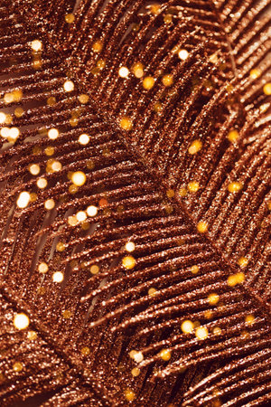 Abstract composition made of a golden decorative branch closeup. Shiny festive and holiday...