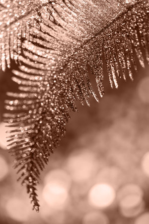 Decorative branch closeup on shiny bokeh background. Abstract holiday backdrop. Celebration and party concept. Color of the year 2025 inspiredの写真素材