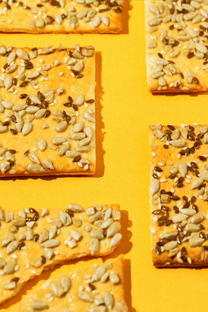 Crunchy cereal cookies on bright orange background. Healthy dessert concept.の写真素材