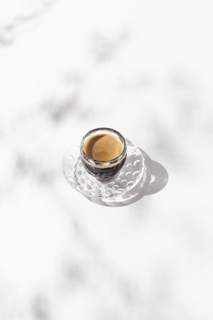 A cup of coffee on white background with shadow. Minimal style.の写真素材
