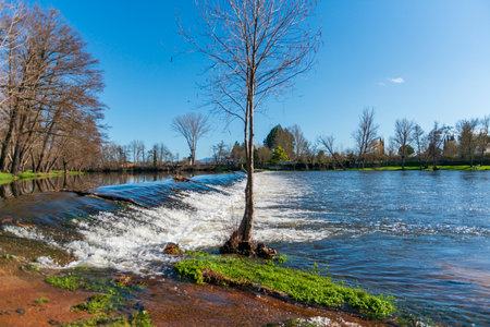A view of a small river on a sunny day in the spring. CITY RODRIGO SALAMANCA SPAINの写真素材