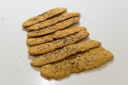 Homemade cookies with black sesame seeds on a white background.の写真素材