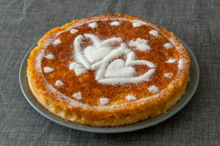 Close-up of a freshly baked pumpkin pie on a gray background.の写真素材