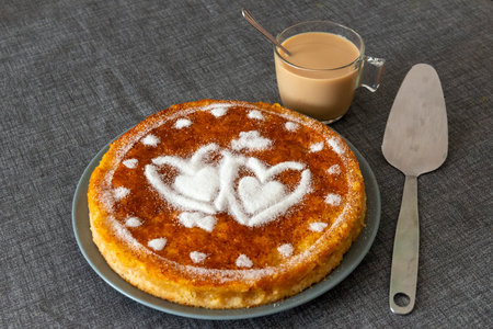 Cottage cheese pancakes with sugar hearts and a cup of coffee.の写真素材