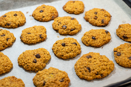 cookies with chocolate chips on a baking sheet. High quality photosの写真素材