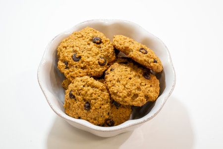 Chocolate chip cookies in a bowl on a white background, top viewの写真素材